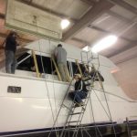 Pic of installation of side salon windows on 55' Hatteras